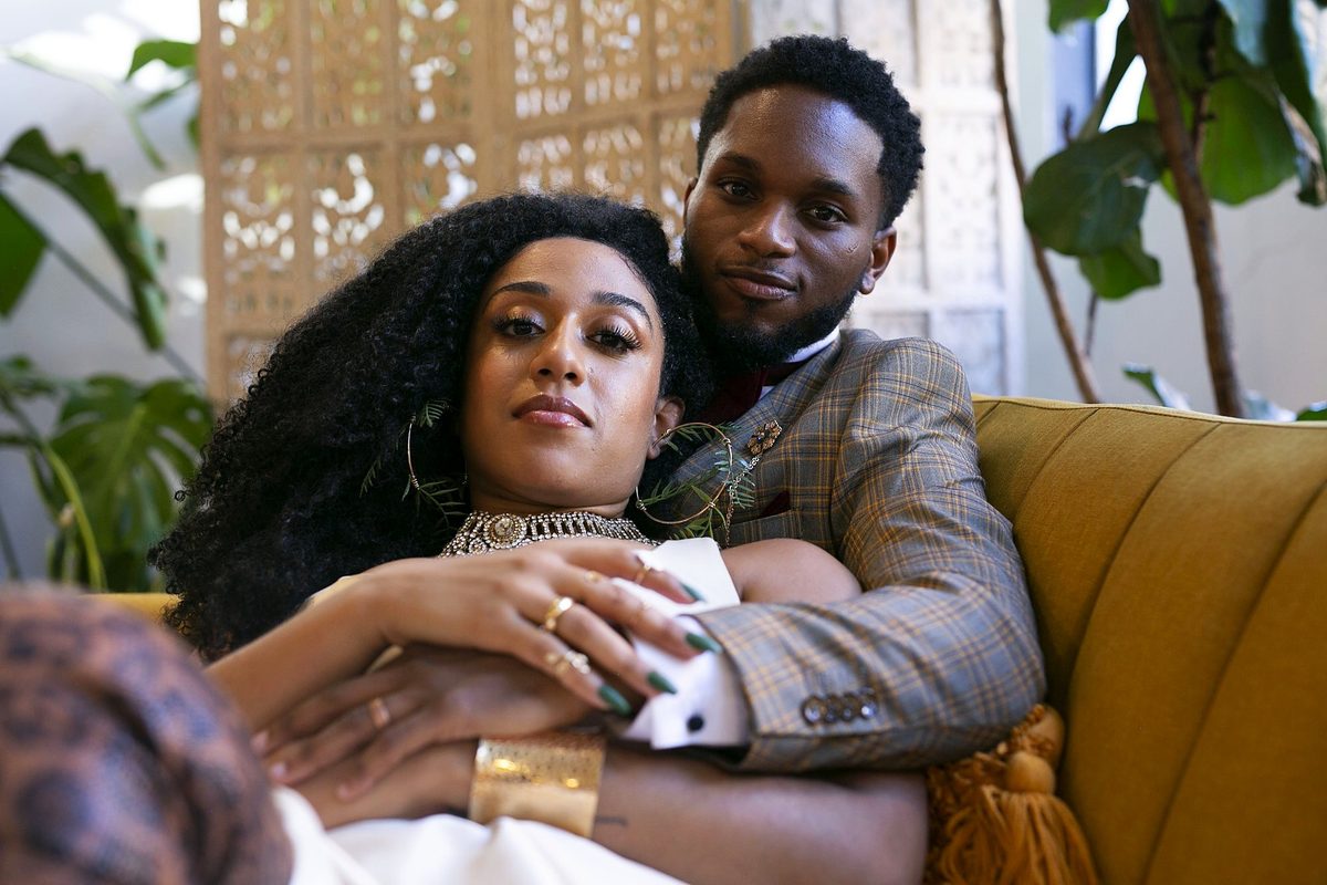 Styled couple portrait on a gold velvet sofa